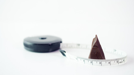 chocolate with measuring tape - diet theme.の写真素材