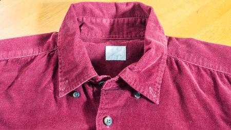 men's shirts colour red close up on wood backgroundの写真素材