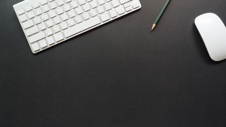 workspace desk with keyboard and pencil copy space background  blackの写真素材