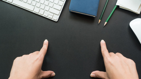 workspace desk with hand copy space background blackの写真素材