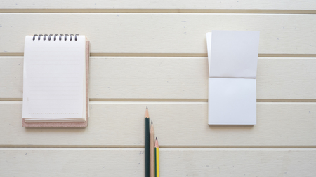 top view with  pencil and notebook on wood backgroundの写真素材