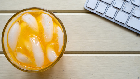 orange juice close up  and keyboard top view relax timeの写真素材
