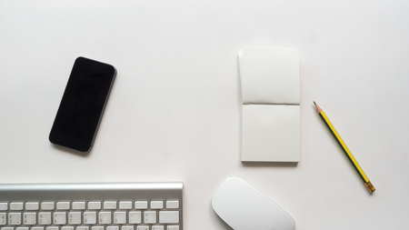 Office desk table with  notebook and smart phone Top viewの写真素材