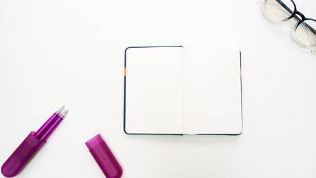 Office desk table with  pen and notebook close up Top view copy space
