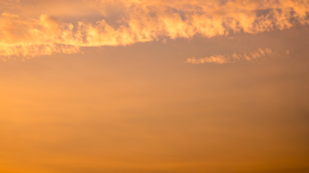 Orange cloudy sky with evening sun background