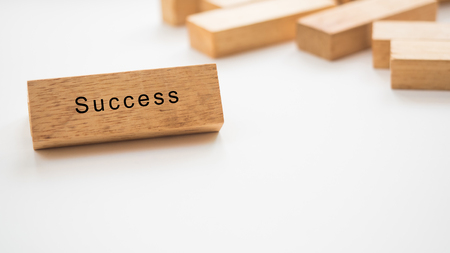 success word written on wood block on white backgroundの写真素材