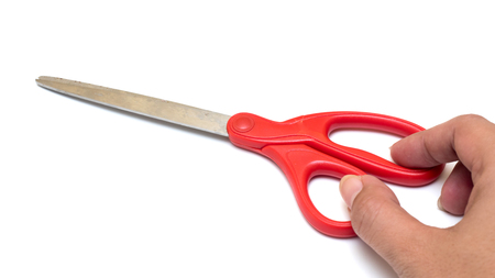 Scissors red Isolated on white background with handの写真素材