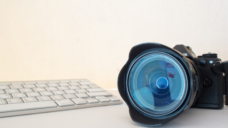 camera and keyboard on white backgroundの写真素材