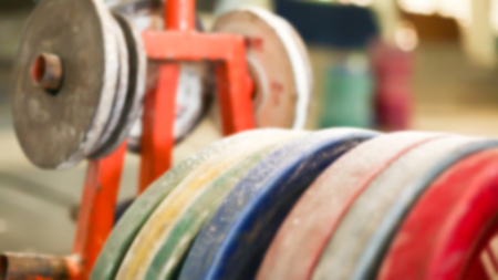 Blur close up Gym equipment with steel plates are coated with colorful rubberの写真素材