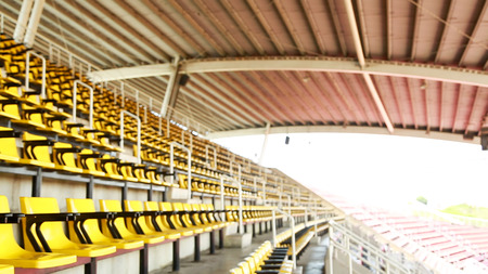 Blur empty yellow seat at Stadium backgroundの写真素材