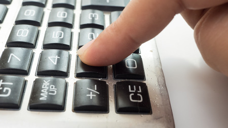 calculator close up with fingerの写真素材