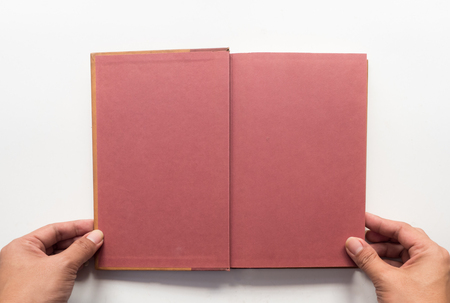 old book topview with hand on white background