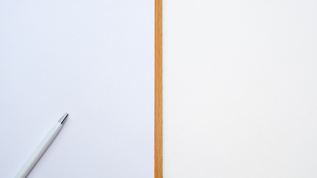 top view paper board with pen closeup  white backgroundの写真素材