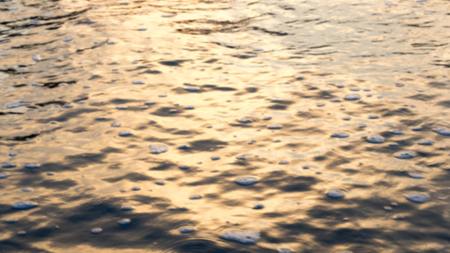 blur sea water close up  background Evening sunの写真素材