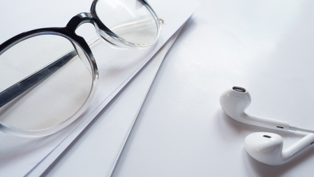 Earphone close up with glasses on white backgroundの写真素材