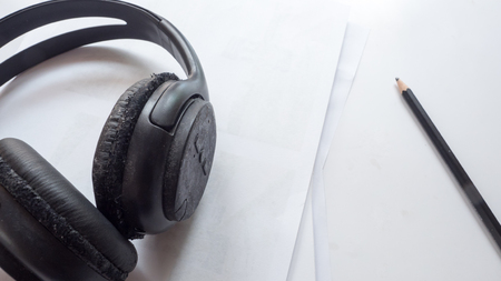 earphone and pencil close up on white backgroundの写真素材