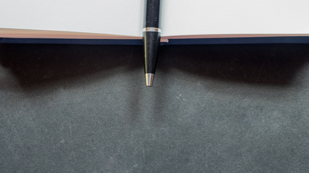 workspace desk copy space top view close up with notebook  black backgroundの写真素材