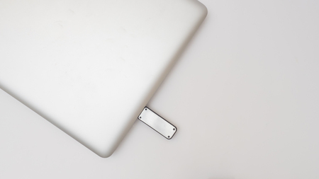 USB port with MacBook Pro on white background connected USB cable