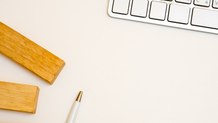 keyboard  and woodenblock with pen close up topview
