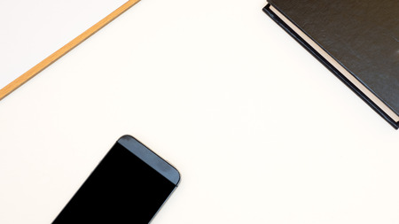 top view smart phone with paperboard white backgroundの写真素材