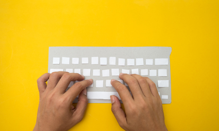 Office desk table Top view with keyboard  yellow background cut styleの写真素材