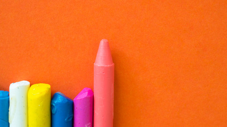 Crayon colorful topview close up on orange background copyspaceの写真素材