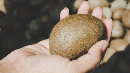 Woman hands holding stones.Human and nature conceptの写真素材