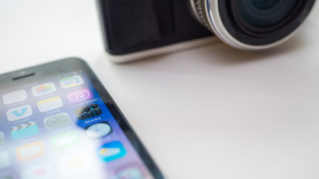 smartphone and camera  on white backgroundのeditorial素材