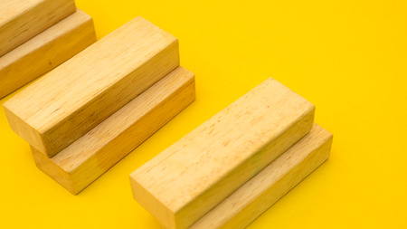 wood block close up yellow backgroundの写真素材