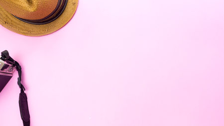 Camera and hat on pink background.Travel conceptの写真素材