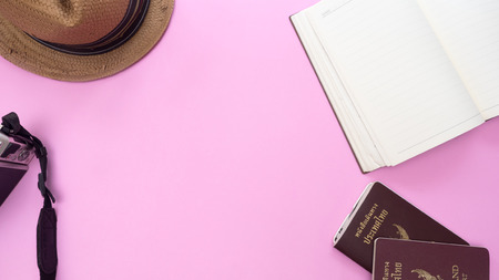 Camera and hat on pink background.Travel concept