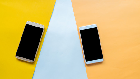 Flat lay, top view office table desk. Workspace with smarth phone on pastel backgroundの写真素材