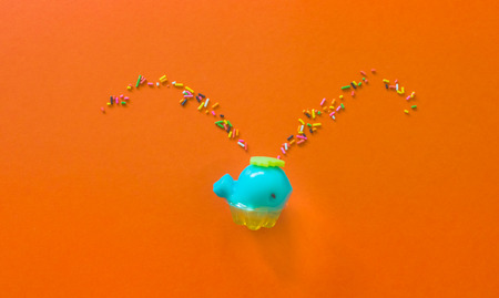 Jelly shape Blue whale spray colored Rainbow Sprinkles.Top view on orange background creative concept.の写真素材