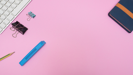notebook and paper cilp with keyboard on pink  background. Pastel color Minimal concept Copy spaceの写真素材