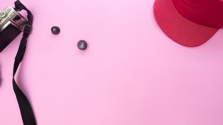 Camera and lens with hat on pink background.Travel conceptの写真素材