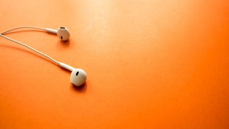 earphone close up on orange backgroundの写真素材