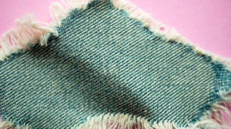 Ripped Jeans on pink backgroundの写真素材