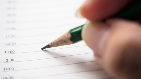 Close up man writing diary or notebook with calendar.Organize planing business event, schedule to...
