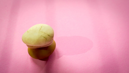 Top view white rock stone stack and shadow.on pink background.Zen concepts.の写真素材
