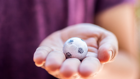 Mini Football in hand close upの写真素材