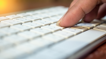 keyboard with hand close up selective focus