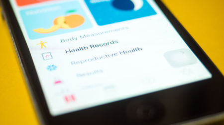 smartphones with health care book app on the screen close upの写真素材