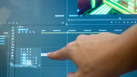 Video editing with desktop. Professional editor with hand for commercial film or movieの写真素材