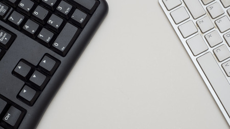 Office desk table with keyboard black and white Top view on white backgroundの写真素材