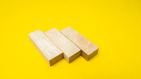 wood block on yellow background