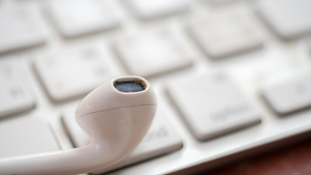 earphone on keyboard close upの写真素材