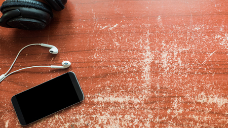 smartphone and earphone on wood tableの写真素材