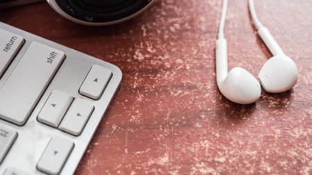 earphone white and keyboard with camera on wood tableの写真素材