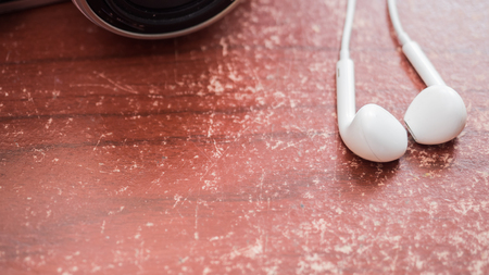 earphone white and camera on wood tableの写真素材