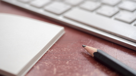 Blank notebook and pencil keyboard close upの写真素材